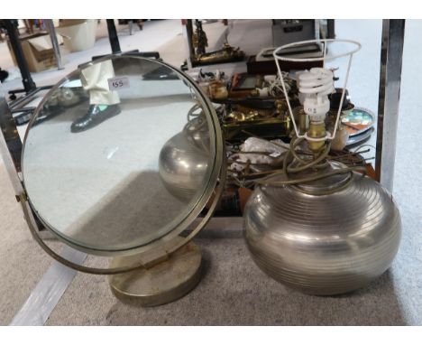 A retro circular glass mirror on stand, together with a aluminium table lamp Condition Report:No condition report available.