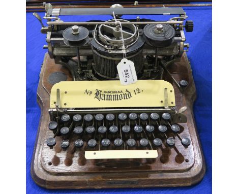 A Hammond No. 12, housed in an oak case, together with an Oliver No. 5 Standard Visible typewriter and a copy of Pitman's Com