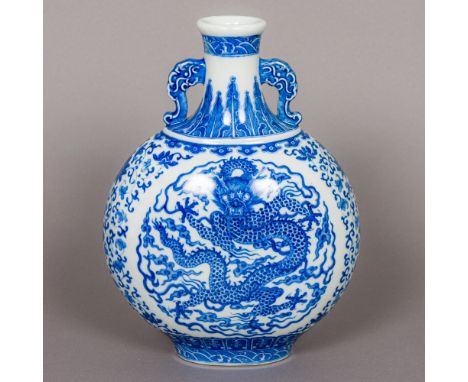 A Chinese porcelain blue and white moon flask With twin mask handles, decorated with a five clawed dragon to either side, the