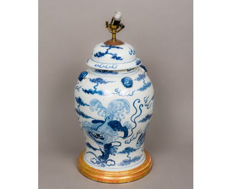 A Chinese blue and white porcelain vaseOf lidded baluster form, decorated in the round with dogs-of-fo amongst stylised cloud