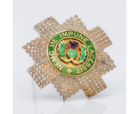 An early 20th century unmarked white and yellow gold diamond and amethyst set enamel decorated regimental badge for the Black