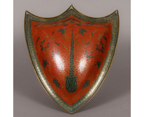 A 19th century Indian copper shield The red and blue enamel ground with scrolling foliate decoration. 42 cm high. CONDITION R