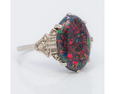 An unmarked white gold or platinum black opal and diamond ringThe claw set cabochon opal above the diamond set shoulders.  1.