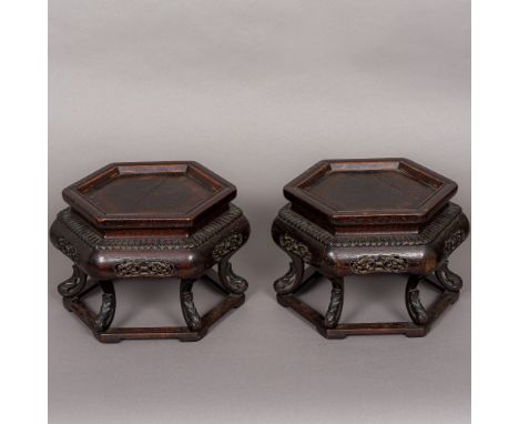 A pair of 19th century Chinese carved wooden urn stands Each of hexagonal form, with pierced frieze and scroll carved feet. E