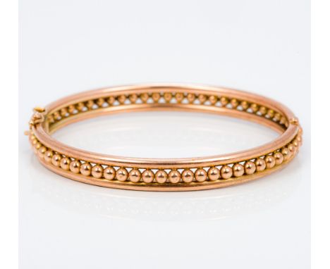 A 9 ct gold bangle form braceletWith central ball decoration.  6.5 cm wide.  CONDITION REPORTS: Generally in good condition, 