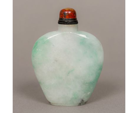 A Chinese jade snuff bottle Of flattened form, with carved bamboo decoration. 7.5 cm high. CONDITION REPORTS: Generally in go