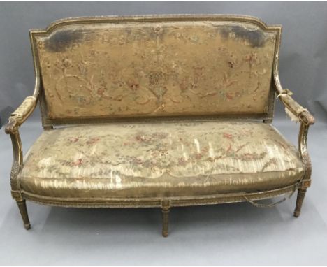 A 19th century French tapestry upholstered giltwood setteeThe florally upholstered padded back issuing twin padded open arms 
