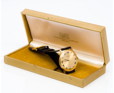 A 9 ct gold International Watch Co (IWC) gentleman's wristwatchThe golden dial with Roman numerals, boxed.  3.5 cm wide.  CON