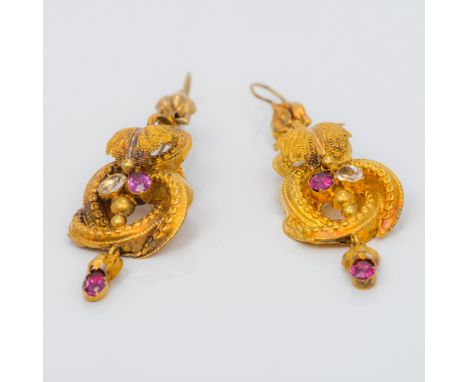 A pair of 19th century unmarked gold diamond and ruby set earringsOf scrolling floral pendant form.  Each 4.75 cm high.  COND