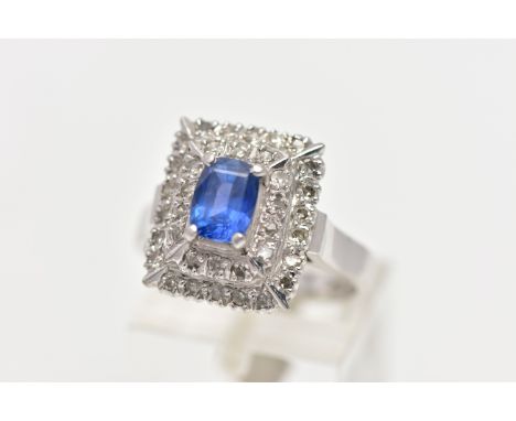 A SAPPHIRE AND DIAMOND CLUSTER RING, set with a rectangular cushion shape sapphire, measuring approximately 6.84mm x 5.18mm, 