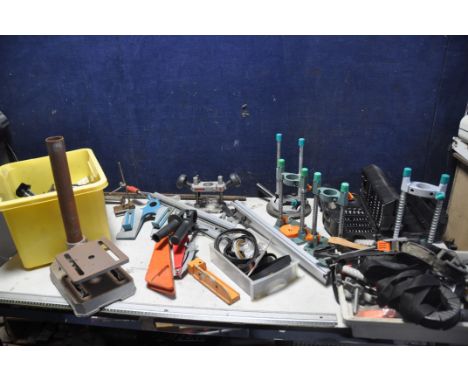 A LARGE COLLECTION OF TOOLS AND ATTATCHMENTS to include router bases, pillar drill/drill press stand, and a tray of clamps an
