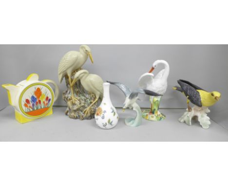 Four bird figures, Goebel golden oriole and silver gull, an early 20th Century swan and stork vase, Moorland Staffordshire te