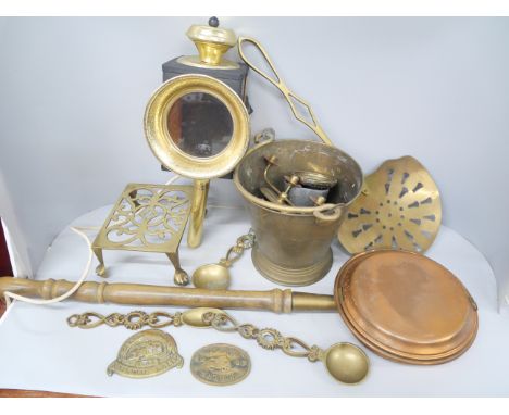 A box of brass and copper including trivet, pail, bed pan, coach light, etc.