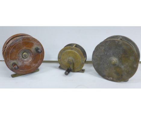 Three vintage fishing reels, two brass, one wooden