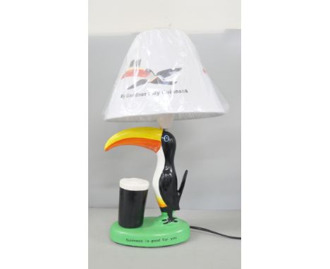 A fibreglass Guinness advertising toucan table lamp with shade. Reads "Guinness is Good For You".