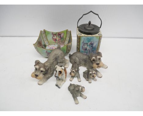 A collection of six porcelain dogs together with a Carltons Fantasia fairy/pixie themed fruit bowl and tea caddy with metal l