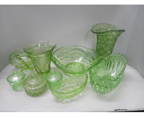 A collection of Art Deco style green glass comprising of jugs, bowls, vases, trinket boxes, and more.