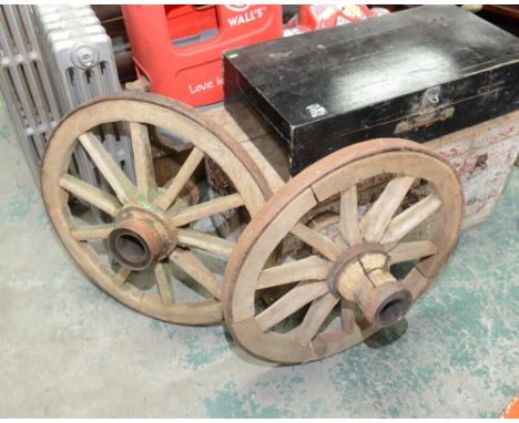A pair of vintage iron bound cart wheels