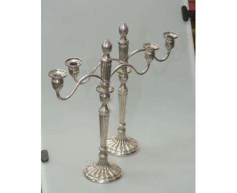 A pair of Chinese export silver twin light candelabrum, each with tapering reeded bodies, the detachable twin lights removing