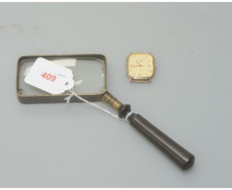 A Vintage magnifying glass with brass mount and turned handle together with a Solvil et Titus quartz gentleman's watch face w