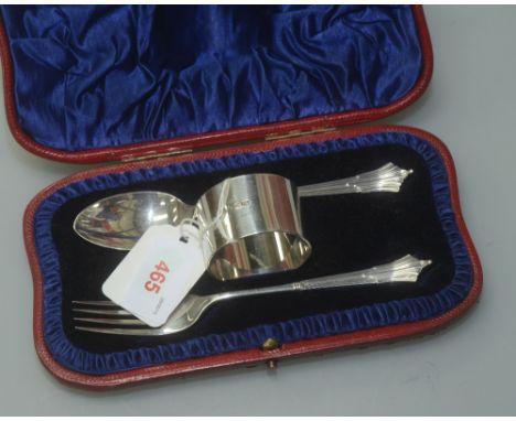 A matched cased silver Christening set comprising a spoon and fork, John Round & Son Ltd. 1901 and a napkin ring, Howard & Ha