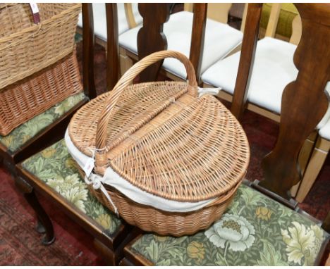 A wicker twin lidded picnic hamper with linen liner