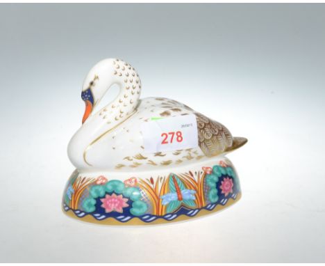 A Royal Crown Derby paperweight, Swan with gold button. 14cm long