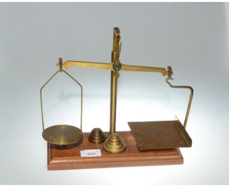 A set of vintage brass postage scales and weights
