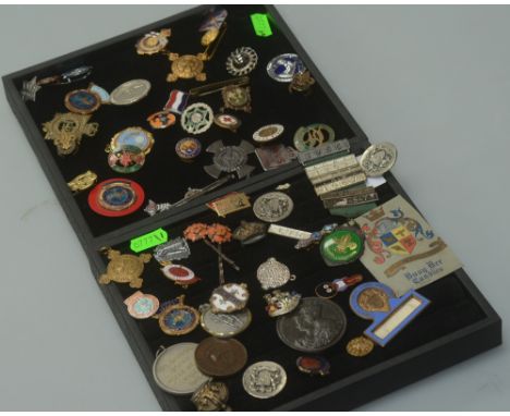 A group of miscellaneous enamel badges, commemorative tokens, two sporting medals, two Armorial buttons, and a trade stamp (q