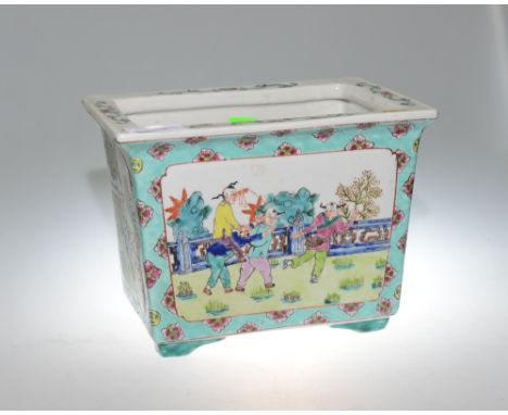 A Chinese rectangular porcelain jardiniere, decorated in enamels with figures playing in a garden