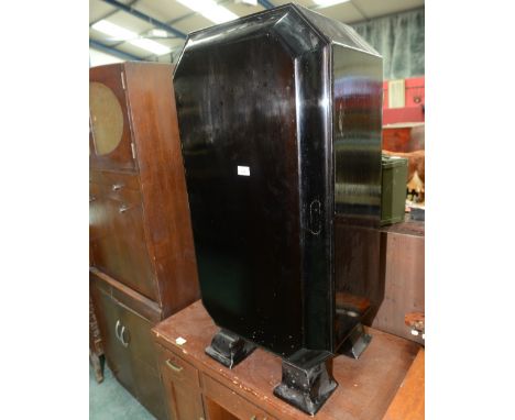 A 1920s Art Deco  ebonised drinks cabinet, the canted rectangular body raised on four legs, the door with discreet handle ope