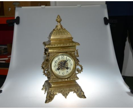 A 19th century brass French mantle clock. The eight day Marti movement striking on a gong, with arabic numerals. The case ela
