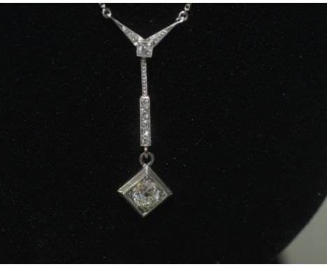 An Art Deco style diamond pendant on chain, the brilliant cut stone in a square setting, suspended from a diamond set bale fu