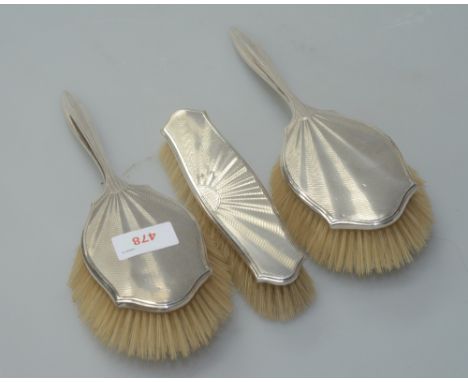 A three piece Art Deco silver backed brush set, Adie Bros, Birminham