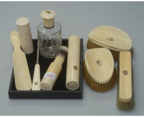 A group of early 20th century ivory dressing table articles comprising three brushes, shoehorn, button hook, shaving brush, s