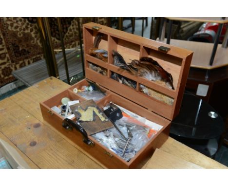 A cased fly tying kit inc. vice, feathers, tools etc