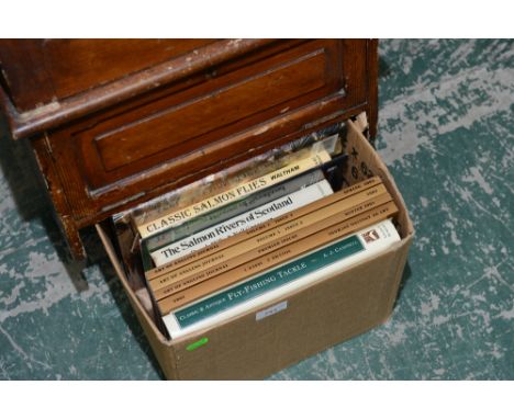 A box containing a quantity of old tackle collecting tog with art of angling journals