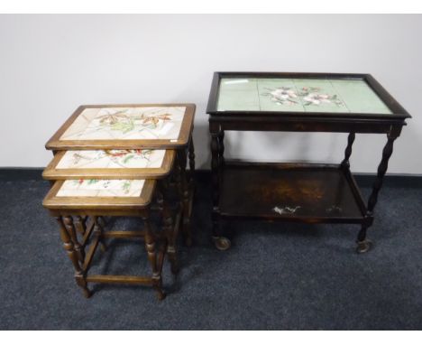 A nest of three oak tile topped table, together with a two tier barley twist tile topped trolley 