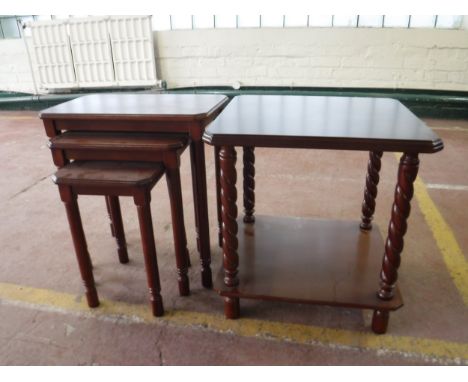 A two tier lamp table and nest of three tables in a mahogany finish 