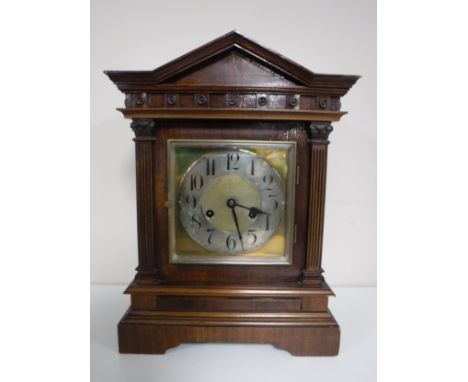 An early 20th century mahogany bracket clock with brass and silvered dial. 