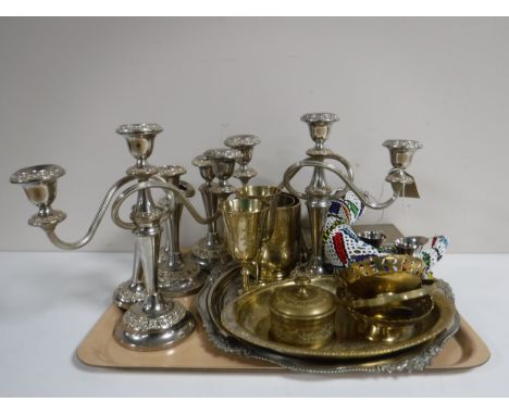A tray of plated candelabra and candlesticks, plated rose ball, milk jugs, assorted brass ware