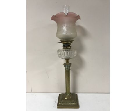 A Victorian glass oil lamp with clear glass reservoir