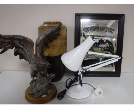 An eagle figure on wooden base, angel poised lamp, West German vase and a Southern Comfort mirror 