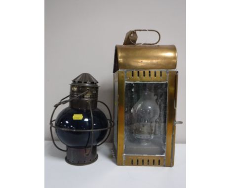 A brass ships lantern together with another ships lamp