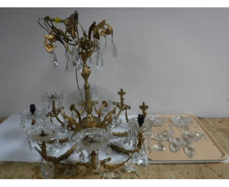 A gilt metal light fitting with glass drops 