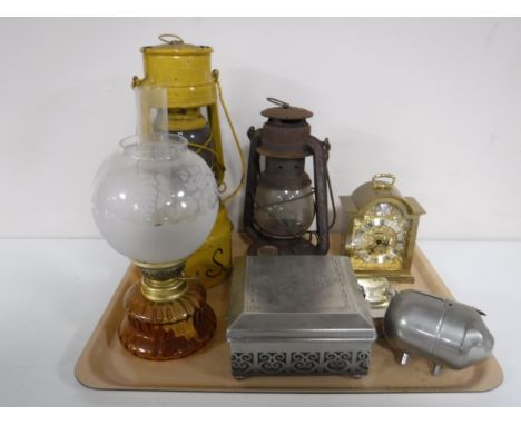A tray of oil lamp, two paraffin lamps, metal table casket, money box, a mantel clock 