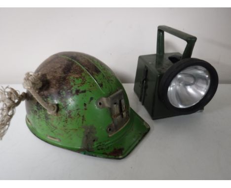 A Campbell vintage helmet, together with a torch