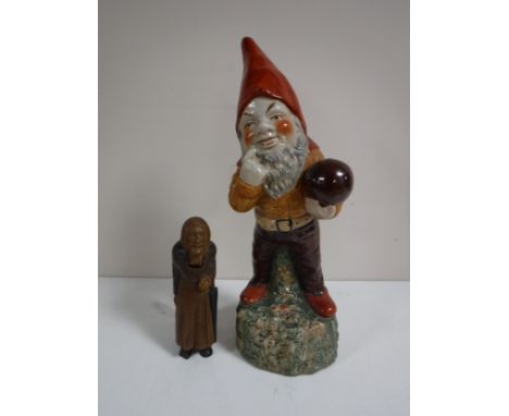 A pottery Gnome figure together with a Swiss wooden nut cracker - Old Lady. (2)