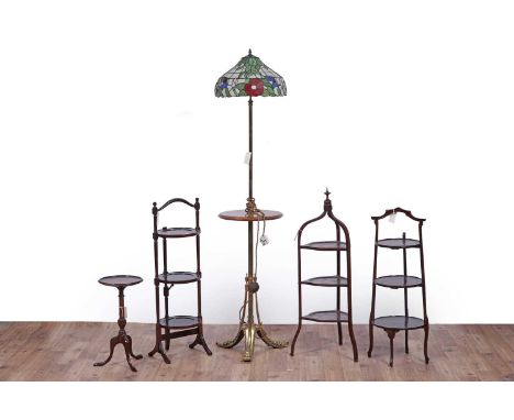 A brass ebonised and fiddle back mahogany standard lamp, with circular Tiffany style shade, raised on brass column with circu
