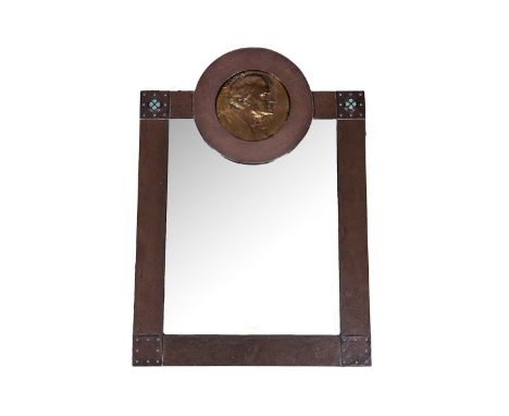 An early 20th Century Arts and Crafts copper mirror, with gilt metal Wagner embossed portrait plaque flanked by turquoise cab